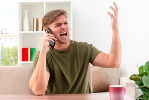 annoyed-young-blonde-handsome-man-sits-table-with-cup-yelling-someone-phone-with-raised-hand_141793-70322